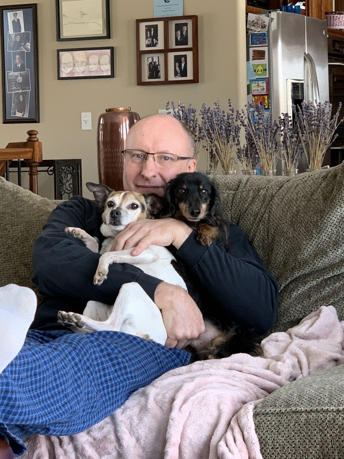 Dr laying with 2 dogs