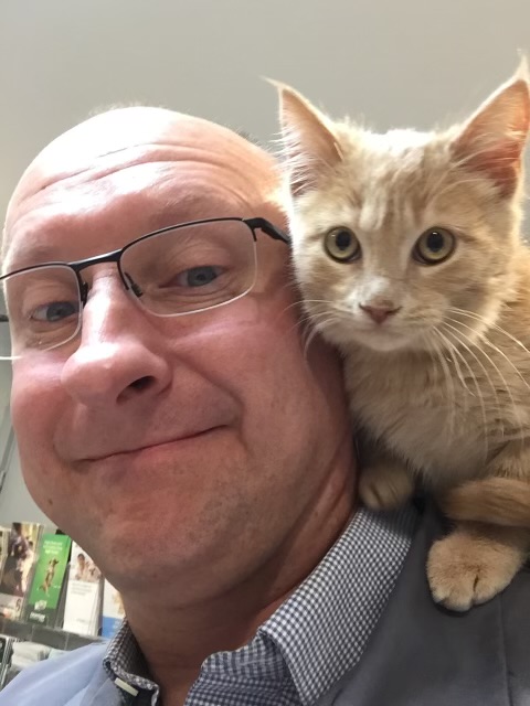 Dr with cat on his shoulder